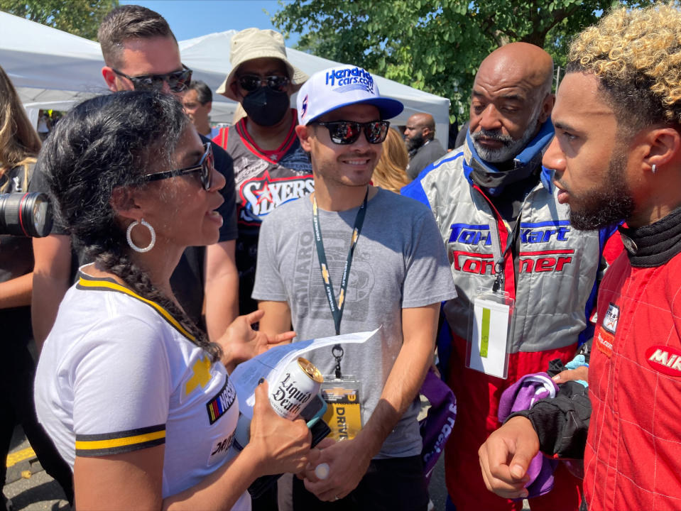 NASCAR driver Kyle Larson, center, talks with members of the Urban Youth Racing School before the start of a race on the grounds of the Please Touch Museum in Philadelphia, Friday, July 22, 2022. (AP Photo/Dan Gelston)