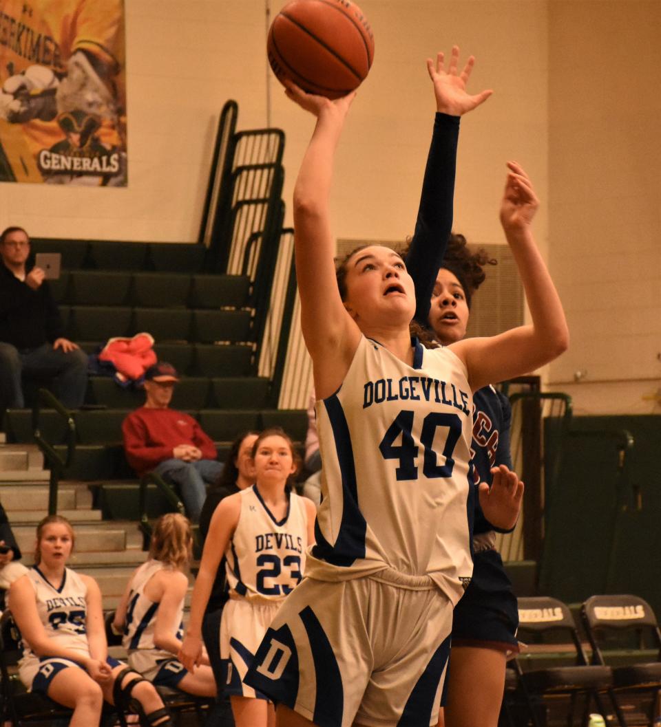 Dolgeville Blue Devil Molly Rauch (40) throws up a shot against the Utica Acadamy of Science at the Utica Board of Officials for Women's Basketball Cancer Challenge Sunday at Herkimer College.