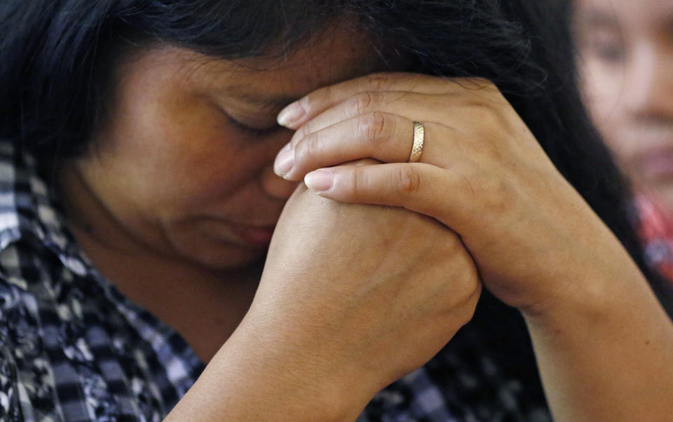 A woman prays during a Spanish Mass at Sacred Heart Catholic Church in Canton, Miss., Sunday, Aug. 11, 2019. Churches have been key to providing spiritual and emotional comfort to workers following immigration raids at seven Mississippi poultry plants, and are now stepping up to provide material aid to jailed or out-of-work church members, even as some church leaders denounce the raids that Republican leaders of the conservative state have applauded. (AP Photo/Rogelio V. Solis)