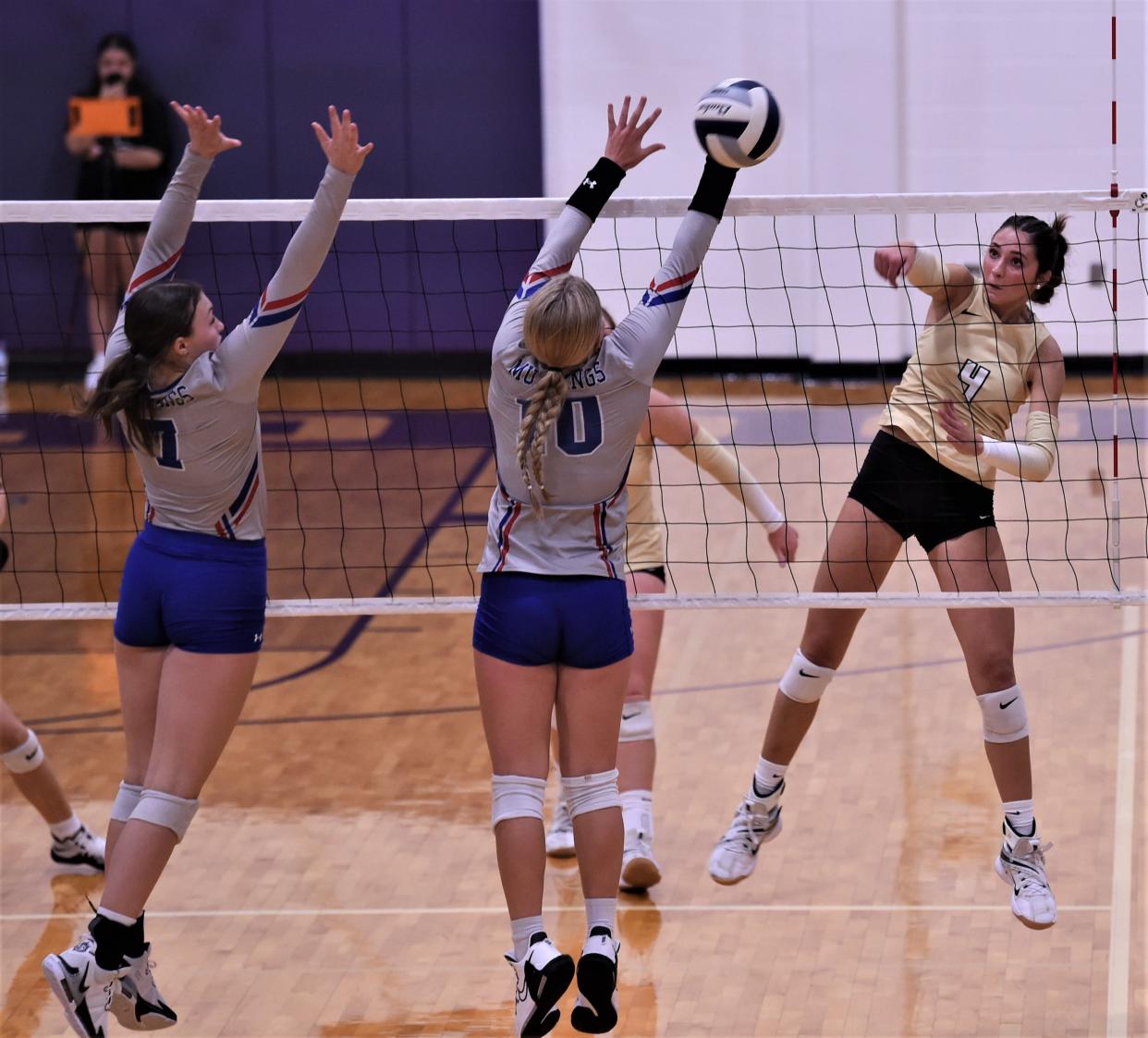 Clyde's Aven Horn, right, watches her shot as Midland Christian's Camdyn Sears (10) and Addi Tatsch defend. Midland Christian beat Clyde 29-27, 27-29, 25-18, 25-20 in the non-district match Aug. 29 at Wylie's Bulldog Gym in Abilene.