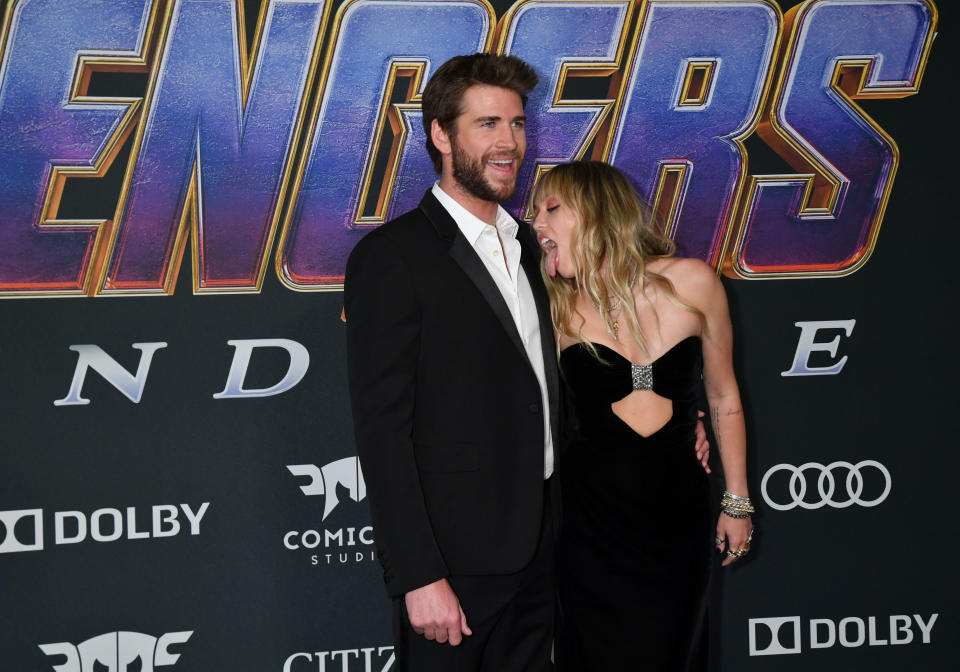 Miley Cyrus licks Liam Hemsworth at the Avengers premiere