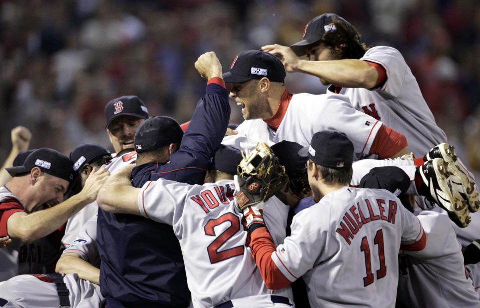 FILE - In this Oct. 27, 2004, file photo, Boston Red Sox players celebrate after defeating the St. Louis Cardinals in Game 4 to win the World Series in St. Louis. The Cardinals and the Red Sox would have had one of their rare regular-season series this week. They have met in four different World Series. They would have played a three-game series at Fenway Park this week if not for the coronavirus pandemic. (AP Photo/Al Behrman, File)