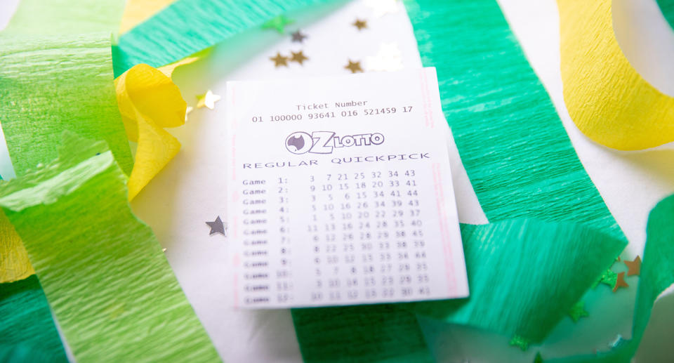 An Oz Lotto ticket sits on top of a pile of streamers and glitter.