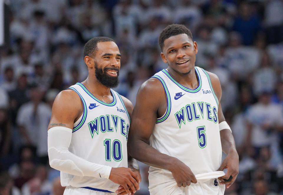 Timberwolves guard Mike Conley (10) and guard Anthony Edwards (5) talk during Game 6 of the Western Conference semifinals against the Nuggets at Target Center in Minneapolis on May 16, 2024.