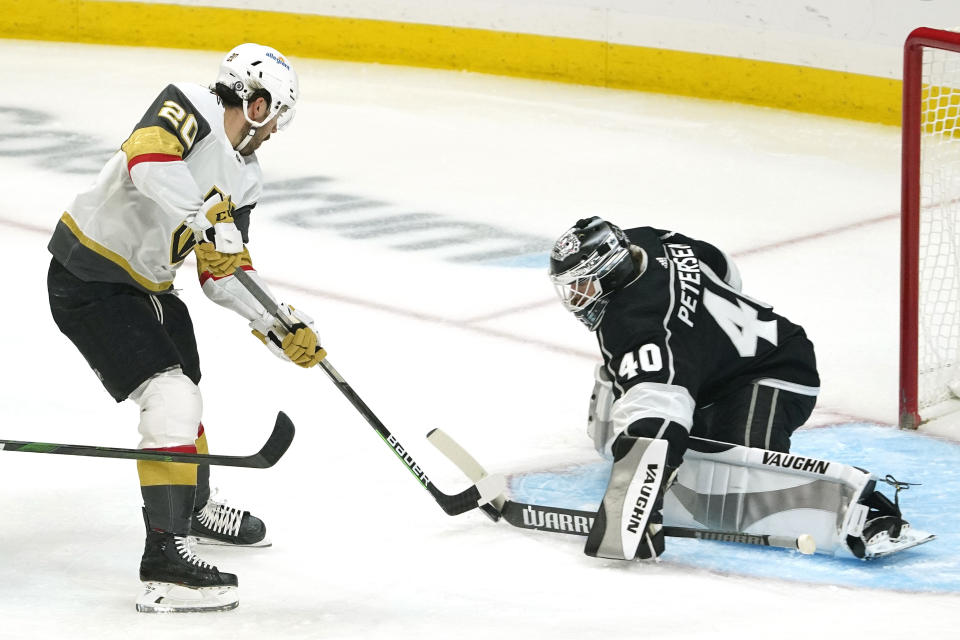 Vegas Golden Knights center Chandler Stephenson, left, tries to get a shot past Los Angeles Kings goaltender Calvin Petersen during the first period of an NHL hockey game Monday, April 12, 2021, in Los Angeles. (AP Photo/Mark J. Terrill)