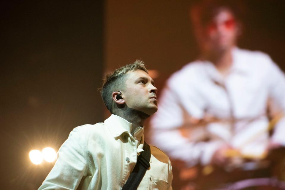 Tyler Joseph, center, from Twenty One Pilots looks out to the crowd while bandmate Joshua Dun performs a drum solo during a concert at Nationwide Arena in Columbus. Joseph claimed this week to have been asked to write a song for "Top Gun: Maverick" before "Tom Cruise came in and just fired everybody."