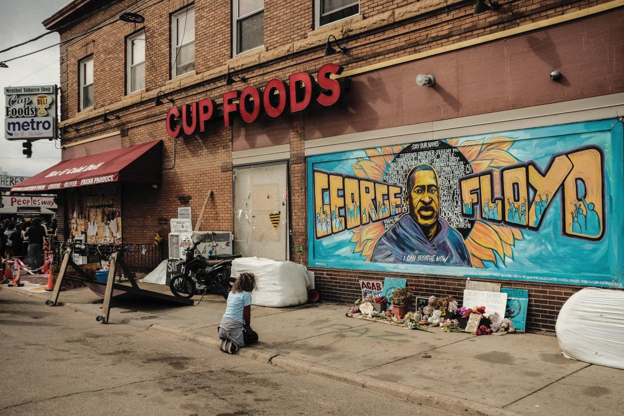 A woman pays respect to a mural of George Floyd by the Cup Foods where he was killed by Minneapolis police officer Derek Chauvin in Minneapolis, Minnesota. (Photo: SOPA Images via Getty Images)