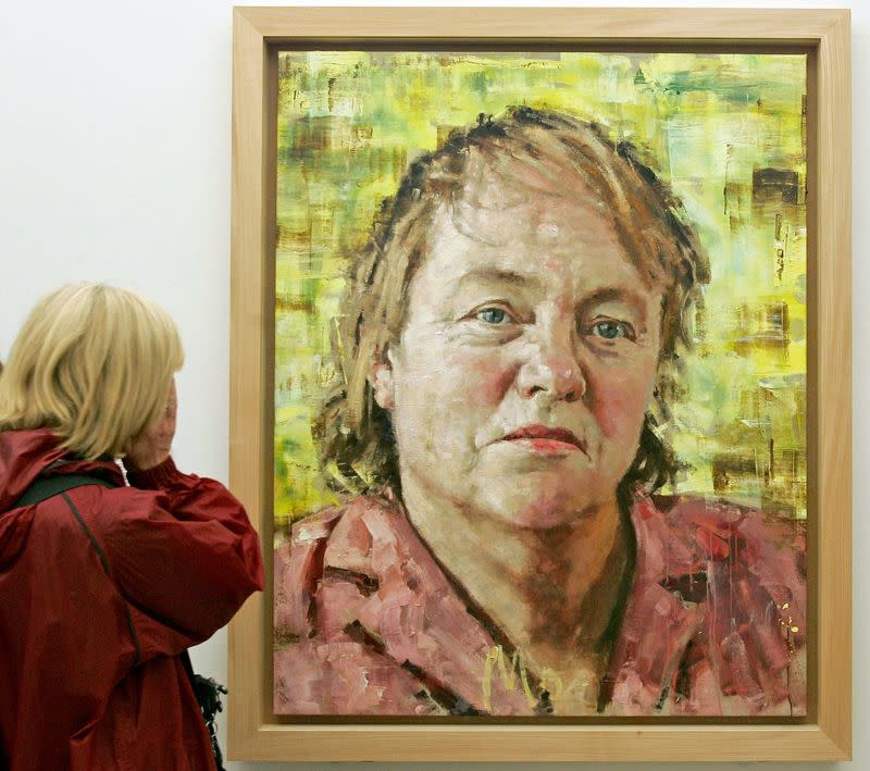 FILE PHOTO: A visitor looks at a painting of British politician Mo Mowlam at the National Portrait Gallery in London.