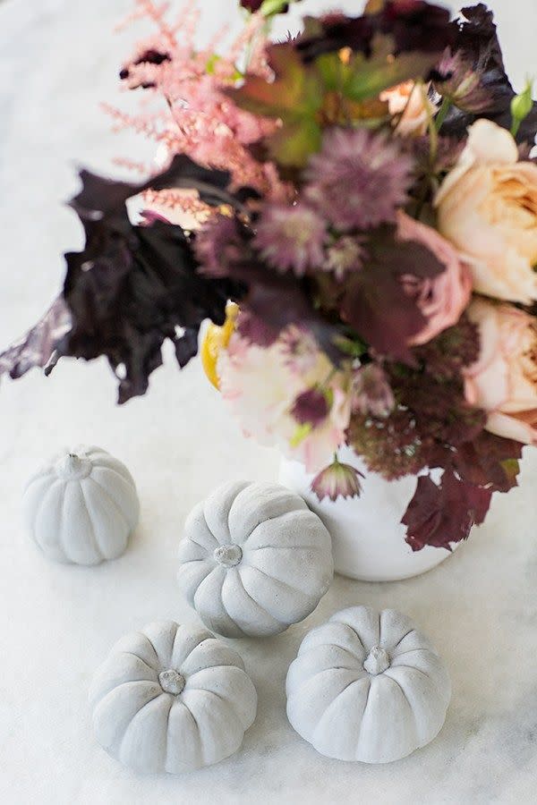 <p>Opt for pinks, peaches, and burgundies in your centerpiece rather than the classic warm orange-y fall palette. Then paint your pumpkins a neutral hue! (Faux pumpkins work, too.)</p><p><a class="link " href="https://www.amazon.com/dp/B07DXJYTDH/ref=sspa_dk_detail_2?psc=1&pd_rd_i=B07DXJYTDH&pd_rd_w=WBv0f&pf_rd_p=7d37a48b-2b1a-4373-8c1a-bdcc5da66be9&pd_rd_wg=8pCEx&pf_rd_r=3HPJ5PPQB68BXBRVR93V&pd_rd_r=787393d8-cc5f-4290-8a7b-391f04d1a31a&spLa=ZW5jcnlwdGVkUXVhbGlmaWVyPUEzNTU0QUg3Skg5MlQwJmVuY3J5cHRlZElkPUEwODUwMzMwMlpCM0UzSU5GT1NUNCZlbmNyeXB0ZWRBZElkPUEwMjUwMjk4MzVUQ1JHT0Y5U0dHTSZ3aWRnZXROYW1lPXNwX2RldGFpbCZhY3Rpb249Y2xpY2tSZWRpcmVjdCZkb05vdExvZ0NsaWNrPXRydWU%3D&tag=syn-yahoo-20&ascsubtag=%5Bartid%7C10057.g.2554%5Bsrc%7Cyahoo-us" rel="nofollow noopener" target="_blank" data-ylk="slk:BUY NOW;elm:context_link;itc:0;sec:content-canvas">BUY NOW</a> <strong><em>Small Artificial Pumpkin, $16</em></strong></p>