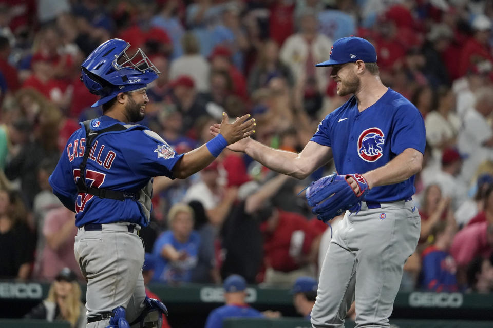 Chicago Cubs relief pitcher Rowan Wick, right, and catcher Erick Castillo celebrate a 6-5 victory over the St. Louis Cardinals in baseball game Saturday, Oct. 2, 2021, in St. Louis. (AP Photo/Jeff Roberson)