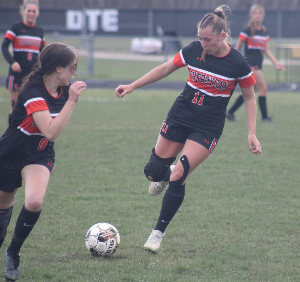 Cheboygan sophomore Jaelyn Wheelock (11) makes a pass while senior teammate Ava Ingelsbe (9) runs during the second half against Houghton Lake on Tuesday.