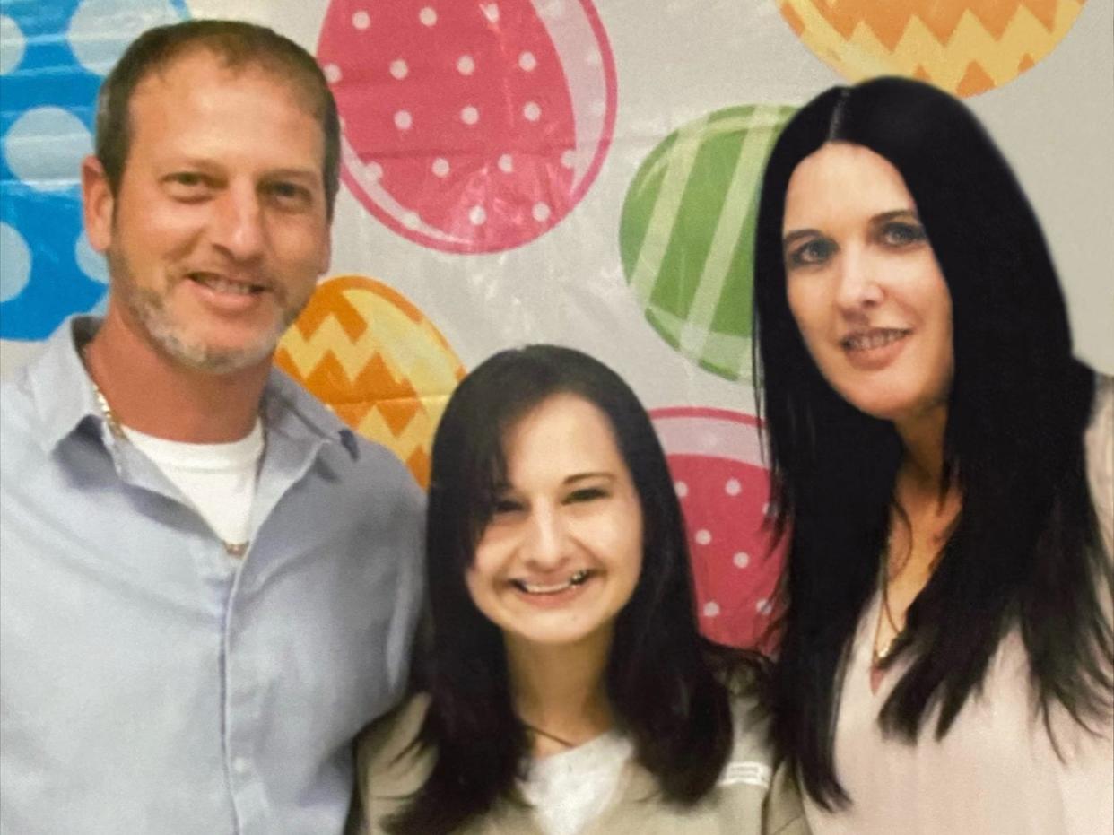 rod, gypsy, and kristy blanchard posing together in prison. gypsy is in a prison uniform in the center and they're all smiling