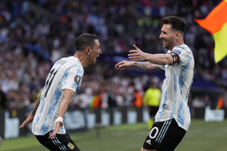 Argentina's Angel Di Maria, left, celebrates with his teammate Lionel Messi after scoring his side's second goal during the Finalissima soccer match between Italy and Argentina at Wembley Stadium in London , Wednesday, June 1, 2022. (AP Photo/Matt Dunham)