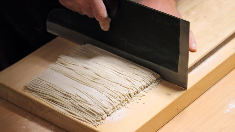 fresh soba noodles being cut