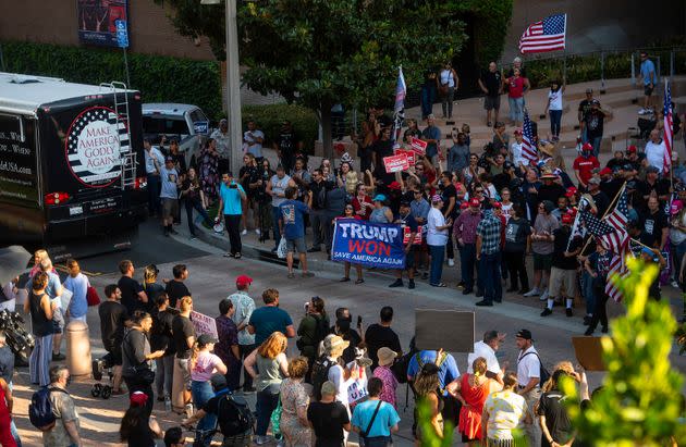 Shouting protesters face off against supporters of Matt Gaetz outside City hall in Riverside, California, Saturday after Gaetz's 