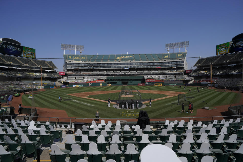 Cutouts are placed at Oakland Coliseum as Chicago White Sox players practice during a baseball workout in Oakland, Calif., Monday, Sept. 28, 2020. The White Sox are scheduled to play the Oakland Athletics in an American League wild-card playoff series starting Tuesday. (AP Photo/Jeff Chiu)