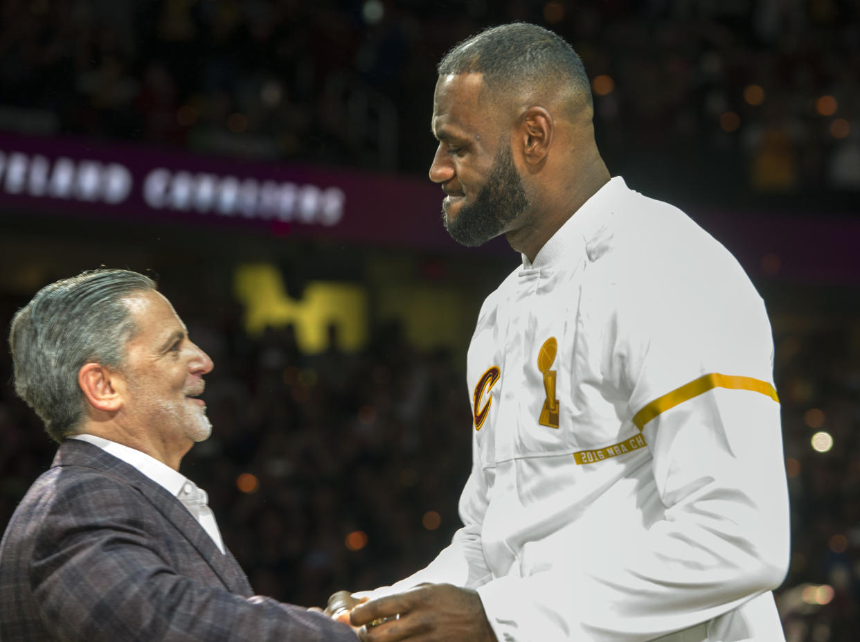 Cavaliers owner Dan Gilbert presents LeBron James with his 2016 championship ring. (AP)