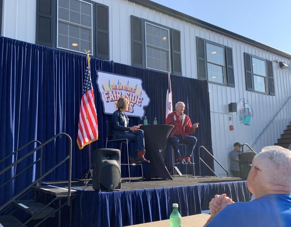 Republican candidate for president and former Arkansas Gov. Asa Hutchinson speaks with Iowa Gov. Kim Reynolds at Gov. Kim Reynolds' Fair-side Chats while campaigning for the 2024 elections at the Iowa State Fair on Tuesday, Aug. 15, 2023.