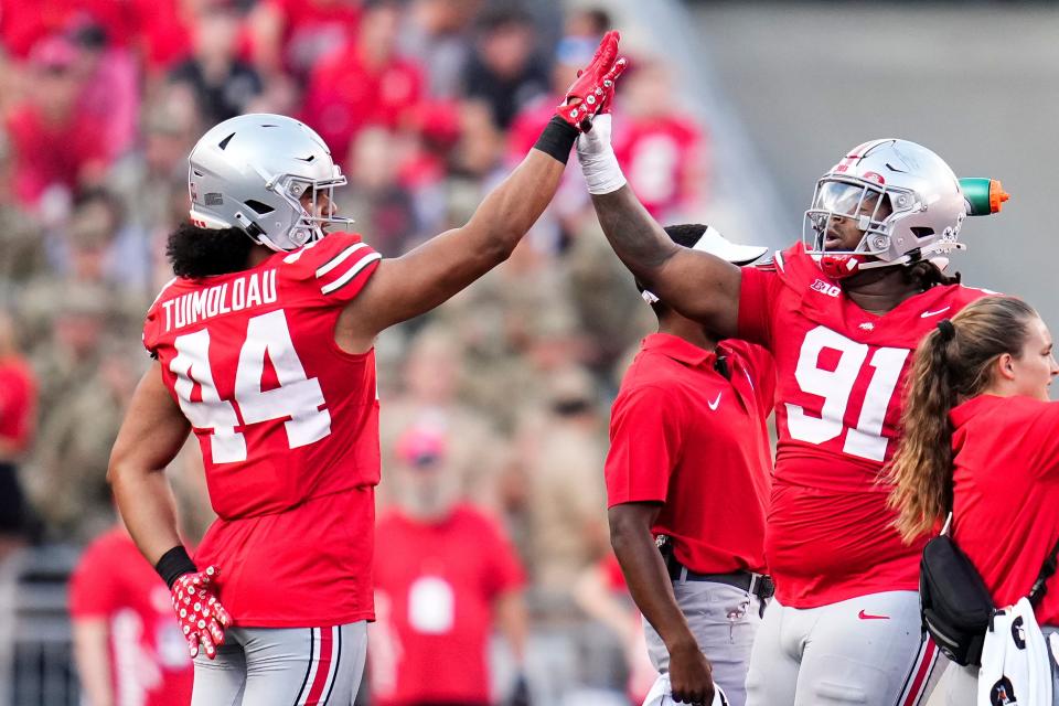 Sep 16, 2023; Columbus, Ohio, USA; Ohio State Buckeyes defensive end JT Tuimoloau (44) high fives defensive tackle Tyleik Williams (91) during the NCAA football game at Ohio Stadium. Ohio State won 63-10.