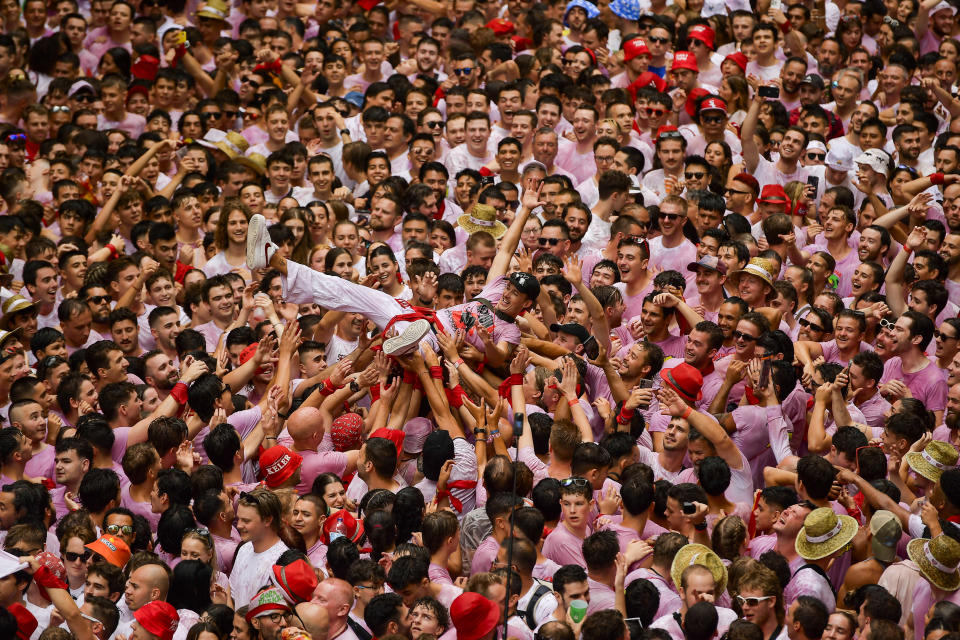 Revellers celebrate during the 'Chupinazo' rocket, to mark the official opening of the 2023 San Fermín fiestas in Pamplona, Spain, Thursday, July 6, 2023. (AP Photo/Alvaro Barrientos)