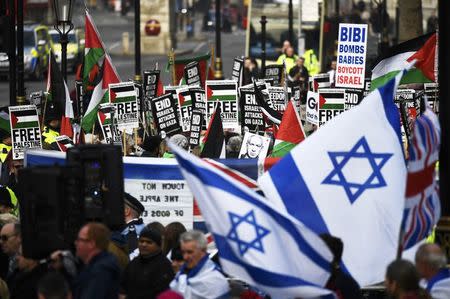 Rival demonstrators hold flags and placards as Israel's Prime Minister Benjamin Netanyahu visits Britain's Prime Minister Theresa May at Downing Street in London, Britain, February 6, 2017. REUTERS/Dylan Martinez