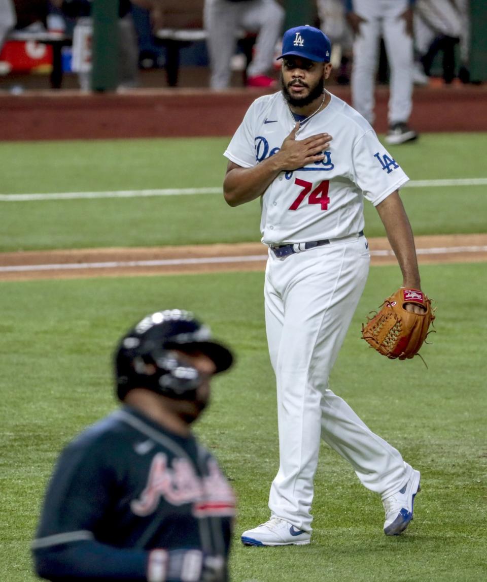 Dodgers relief pitcher Kenley Jansen taps his chest after retiring Pablo Sandoval to save a 3-1 win.