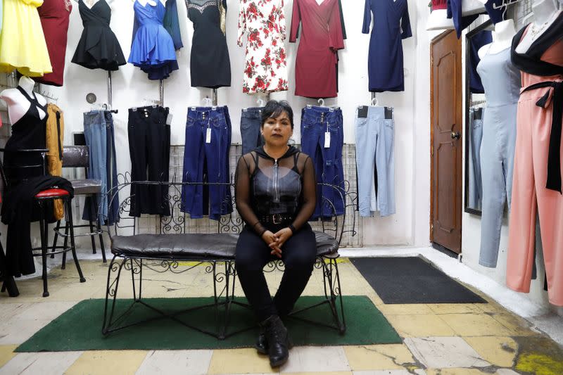 Maria Guadalupe, 45, poses for a photo inside a clothes shop in Ecatepec, State of Mexico