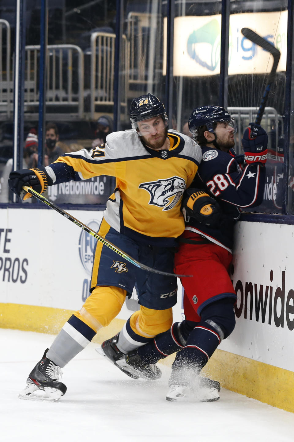 Nashville Predators' Jarred Tinordi, left, checks Columbus Blue Jackets' Oliver Bjorkstrand during the second period of an NHL hockey game Thursday, Feb. 18, 2021, in Columbus, Ohio. (AP Photo/Jay LaPrete)