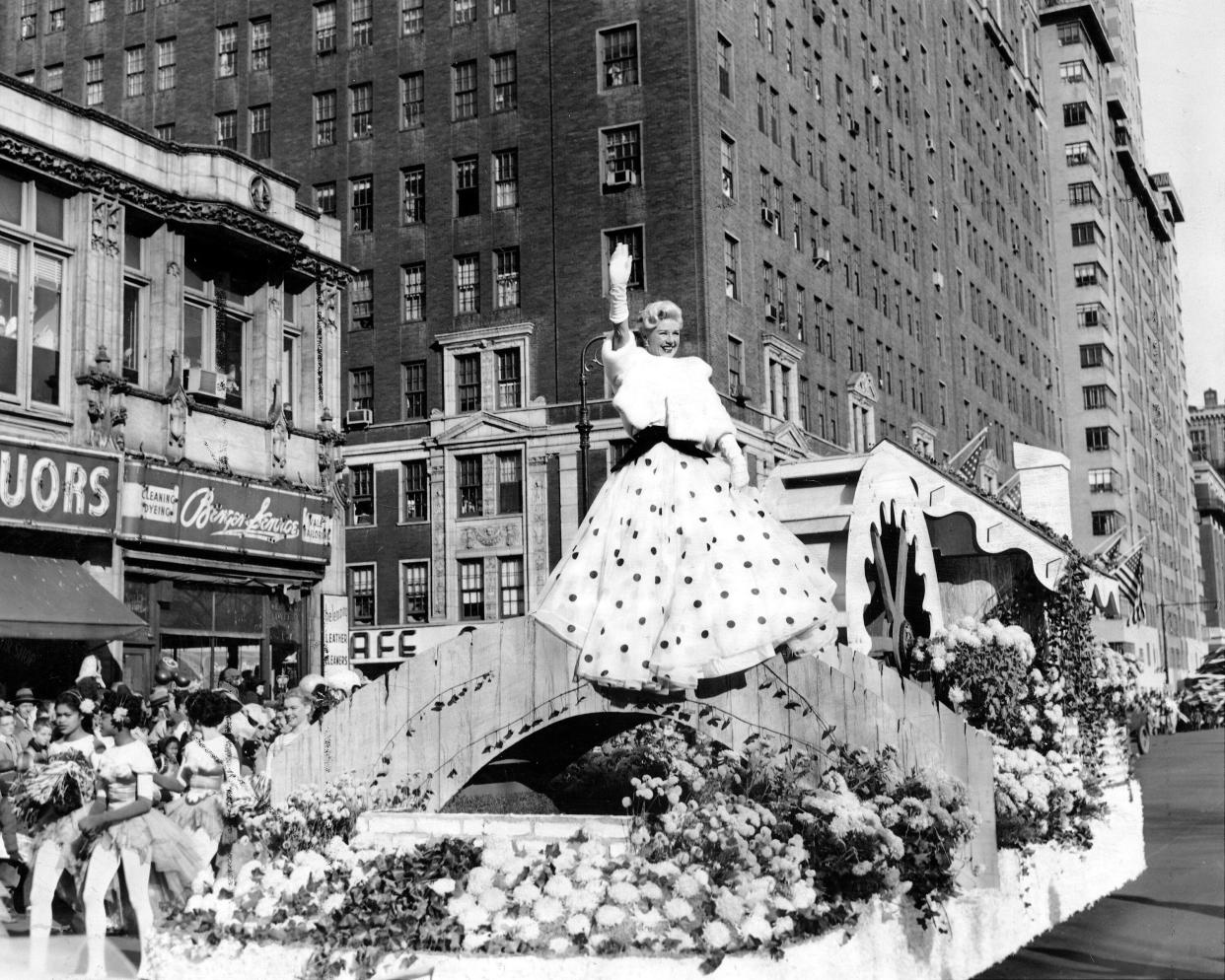 Film star Ginger Rogers waving from the flower float