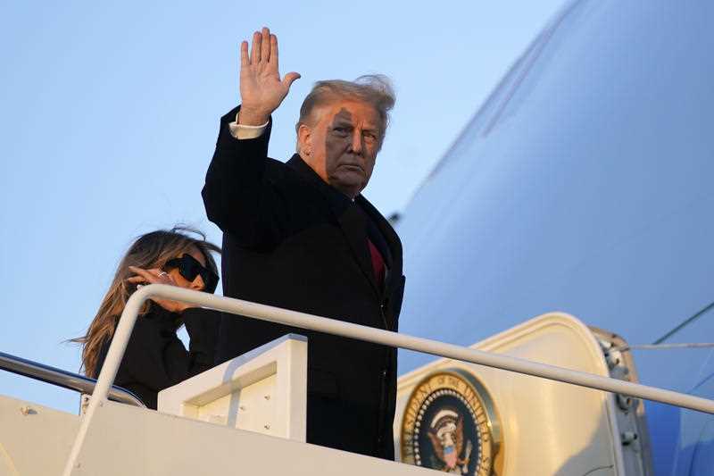 President Donald Trump waves as he boards Air Force One at Andrews Air Force Base.