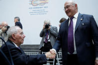 German Finance Minister Wolfgang Schaeuble (L) shakes hands with French Finance Minister Michel Sapin after G-20 family photo during the IMF/World Bank spring meetings in Washington, U.S., April 21, 2017. REUTERS/Yuri Gripas