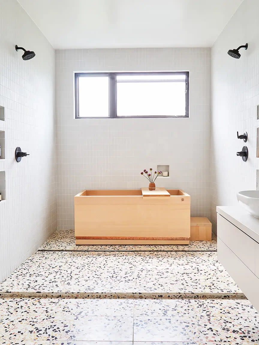 Bathroom with wood Japanese soaker tub and terrazzo tile. 