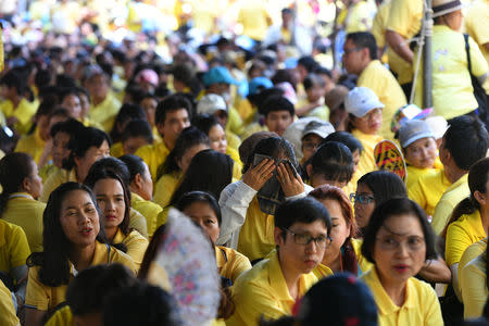 People wait in line to pass through a security check before attending a coronation procession for Thailand's newly crowned King Maha Vajiralongkorn in Bangkok, Thailand May 5, 2019. REUTERS/Chalinee Thirasupa