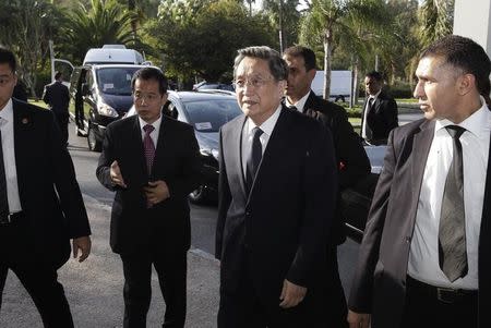 China's Yu Zhengsheng (C), chairman of the National Committee of the Chinese People's Political Consultative Conference (CPPCC) , is escorted by staff members as he arrives at the Foreign Ministry in Rabat. Picture taken on November 3, 2014. REUTERS/Stringer