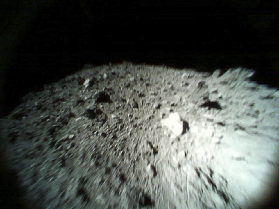 This Oct. 26, 2018, image captured by Rover-1A, and provided by the Japan Aerospace Exploration Agency (JAXA) on Thursday, Dec. 13, 2018, shows the surface of asteroid Ryugu. Japan's space agency JAXA said Thursday, Dec. 13, 2018, more than 200 photos taken by two small rovers on the asteroid show no signs of a smooth area for the planned touchdown of a spacecraft early next year. (JAXA via AP)