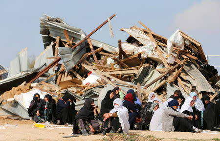 Arab Israeli women sit next to the ruins of their dwellings which were demolished by Israeli bulldozers in Umm Al-Hiran, a Bedouin village in Israel's southern Negev Desert January 18, 2017. REUTERS/Ammar Awad