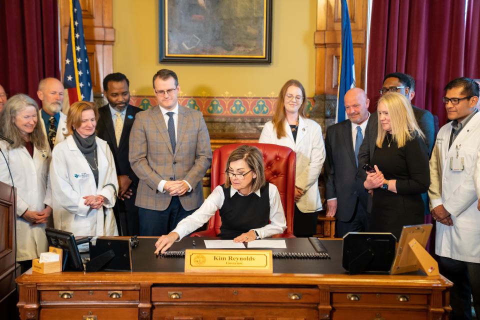 Governor Kim Reynolds signs a bill that will create a cap on noneconomic damages in medical malpractice cases, Thursday, Feb. 16, 2023.