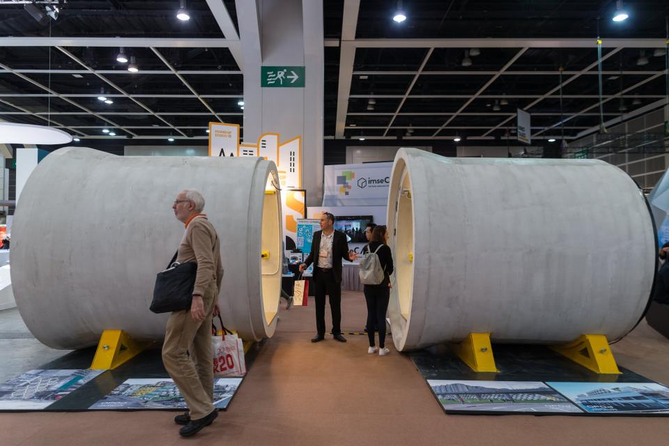 Visitors look at the inside the OPod Tube House on display during the Design Inspire exhibition in Hong Kong (EFE/EPA/JEROME FAVRE)