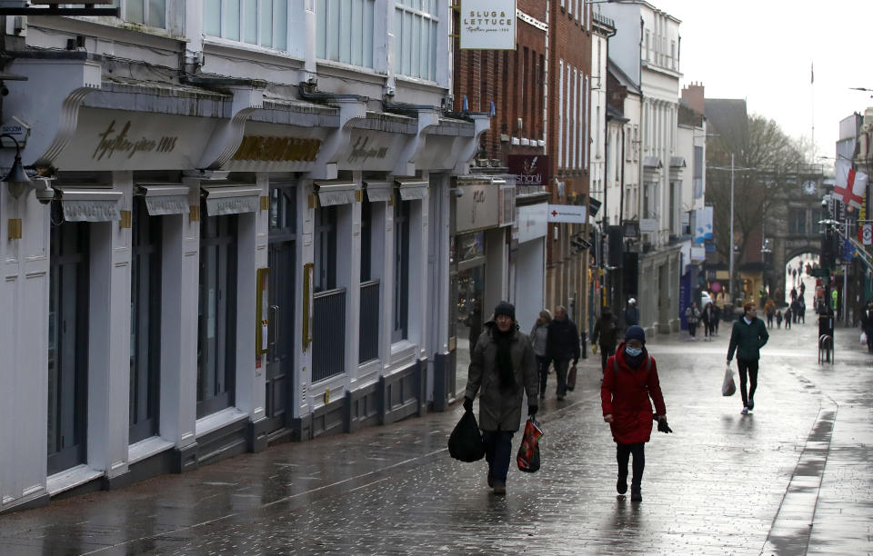 Shoppers walk past closed shops in Lincoln city centre during England's third national lockdown to curb the spread of coronavirus. Under increased measures people can no longer leave their home without a reasonable excuse and schools must shut for most pupils. (Photo by Tim Goode/PA Images via Getty Images)