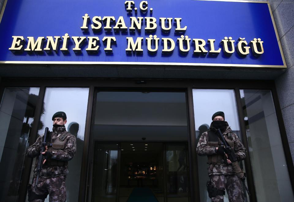 Turkish police officers stand guard at Istanbul's headquarters following a news conference regarding the arrest of a suspect of New Year's nightclub attack in Istanbul, Tuesday, Jan. 17, 2017. Turkish officials on Tuesday confirmed that the gunman who carried out the deadly New Year's attack on an Istanbul nightclub, which was claimed by the Islamic State group, has been detained. The sign reads in Turkish: "Istanbul Police Department'." (AP Photo/Lefteris Pitarakis)