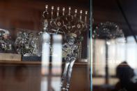 A menorah and other Judaica sit in a cabinet at Lea and Yehuda Evron's apartment in the Queens borough of New York