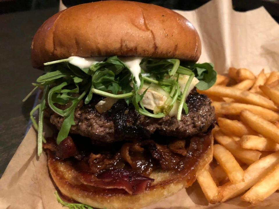 The Clarence Page burger with brie, caramelized onion, fig jam, bacon, garlic aioli and arugula at the North Street Press Club restaurant in Farmville.