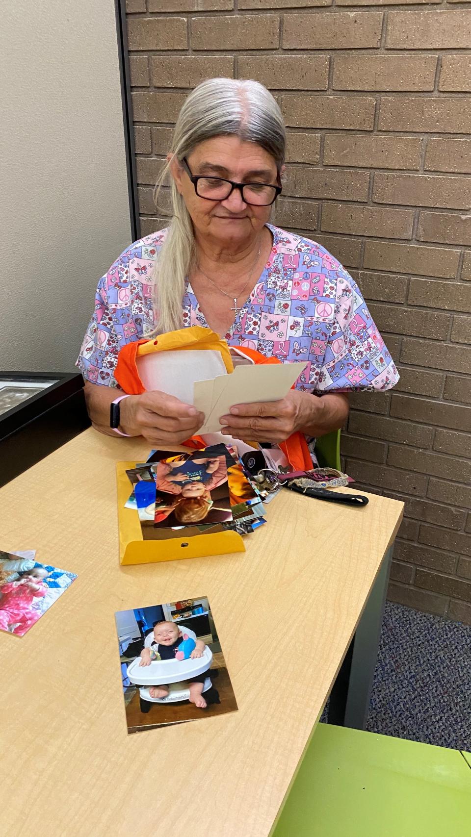 Kathy Ellerbe looks at photos of her grandson, Levi Cole Ellerbe, on July 28. The baby died on July 18, 2018, and his mother and her girlfriend are in prison after pleading guilty to charges in his death.