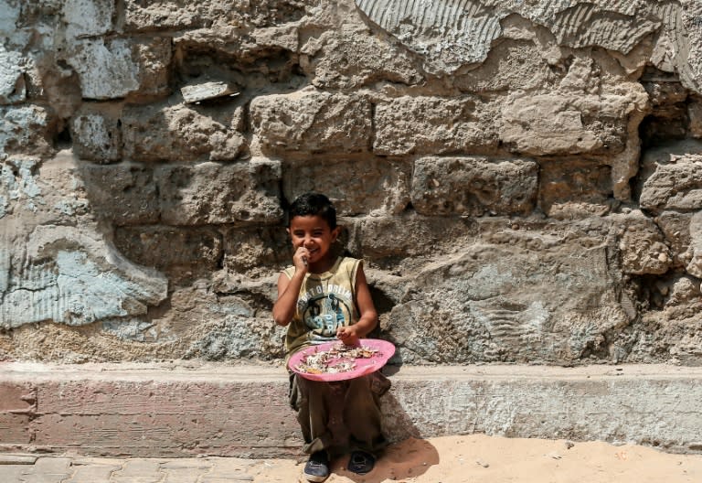 A Palestinian child eats pumpkin seeds in Gaza City on September 1, 2018