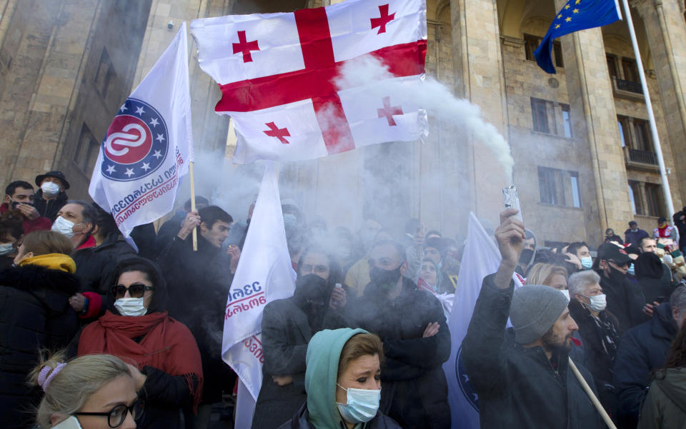 Georgian opposition supporters attend a rally following the detention of the United National Movement party leader Nika Melia, Tbilisi, Georgia, Tuesday, Feb. 23, 2021. Protesters denouncing the arrest of the head of Georgia's main opposition party have set up tents outside the country's parliament building and blocked the capital's main avenue. Tensions in Georgia have been strong since the October parliamentary election that the opposition is demanding be rerun. (AP Photo/Shakh Aivazov)