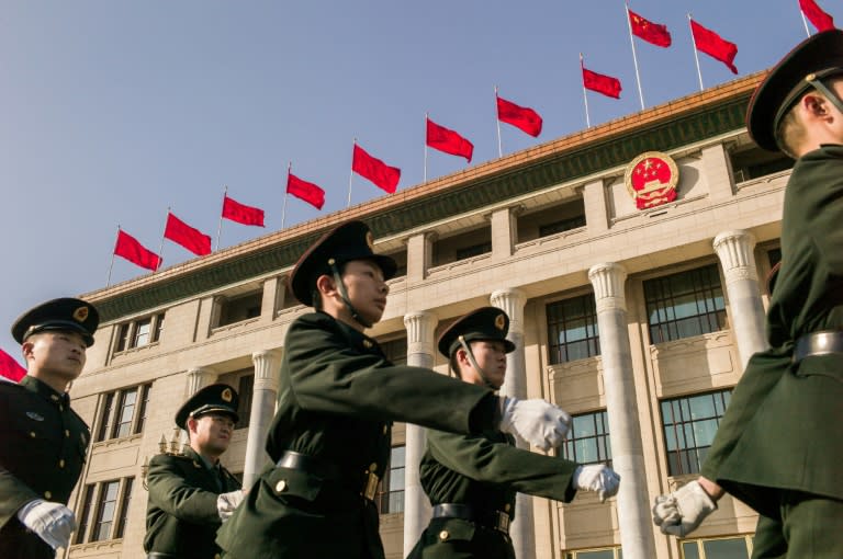 Chinese soldiers march past the Great Hall of the People ahead of the opening session of the Chinese People's Political Consultative Conference (CPPCC) in Beijing, on March 2, 2017