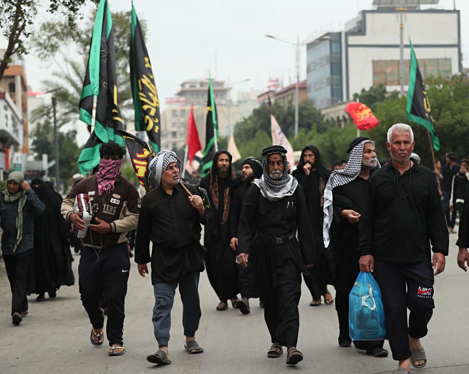 Although many shrines are closed due to the new coronavirus, Shiite pilgrims make their way to the shrine of Imam Moussa al-Kadhim, a key Shiite saint, during preparations for the annual commemoration of his death, in Baghdad, Iraq, Wednesday, March 18, 2020. Iraq announced a weeklong curfew to help fight the spread of the virus. For most people, the virus causes only mild or moderate symptoms. For some it can cause more severe illness. (AP Photo/Hadi Mizban)