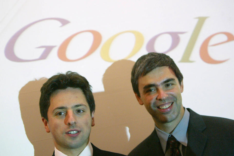 FRANKFURT/MAIN, GERMANY:  Google founders Sergey Brin (L) and Larry Page pose for photographers prior to presenting their new Google Print product at the Frankfurt Book Fair 07 October 2004.  AFP PHOTO JOHN MACDOUGALL  (Photo credit should read JOHN MACDOUGALL/AFP via Getty Images)