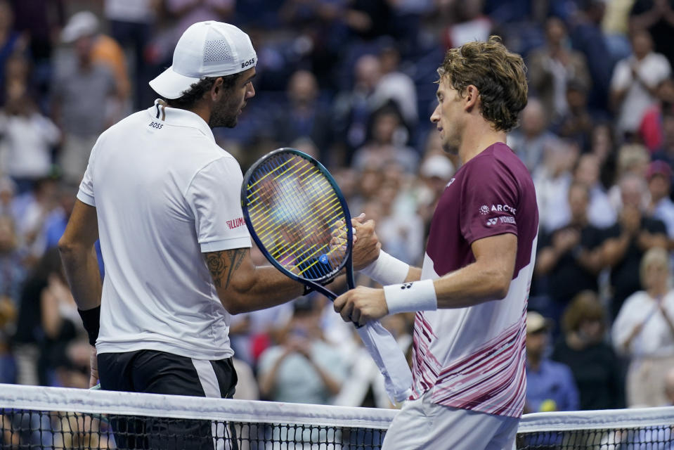 Casper Ruud, of Norway, right, shakes hands with Matteo Berrettini, of Italy, after winning their quarterfinal match of the U.S. Open tennis championships, Tuesday, Sept. 6, 2022, in New York. (AP Photo/Seth Wenig)