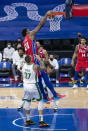 Philadelphia 76ers' Joel Embiid, top, dunks with Boston Celtics' Daniel Theis, left, defending during the first half of an NBA basketball game, Friday, Jan. 22, 2021, in Philadelphia. (AP Photo/Chris Szagola)